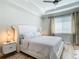 The main bedroom has a large bed, ceiling fan, and lots of natural light at 2186 Yalta Ter, North Port, FL 34286