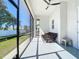 Relax on this screened porch featuring a ceiling fan and an outdoor seating area at 2186 Yalta Ter, North Port, FL 34286