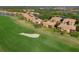 Scenic aerial view of community homes overlooking a lush green golf course and serene lake at 322 Winding Brook Ln # 103, Bradenton, FL 34212