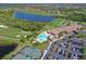 Aerial view of the community featuring a golf course, lakes, clubhouse, community pool, and tennis courts at 322 Winding Brook Ln # 103, Bradenton, FL 34212