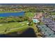 Aerial view of the community featuring a golf course, lakes, clubhouse, community pool, and tennis courts at 322 Winding Brook Ln # 103, Bradenton, FL 34212