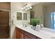 Bathroom featuring double sinks, a large mirror, and a glass shower at 322 Winding Brook Ln # 103, Bradenton, FL 34212