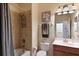 Bathroom with tub/shower combination, updated vanity, and decorative accents at 322 Winding Brook Ln # 103, Bradenton, FL 34212