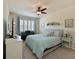 Bright bedroom featuring a ceiling fan, piano, and neutral decor at 322 Winding Brook Ln # 103, Bradenton, FL 34212