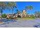 A clubhouse exterior with manicured landscaping, an American flag, and a light stone facade at 322 Winding Brook Ln # 103, Bradenton, FL 34212