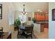 Charming dining area with a round table, plantation shutters, and view of kitchen at 322 Winding Brook Ln # 103, Bradenton, FL 34212