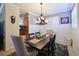 Inviting dining area boasts stylish lighting, plantation shutters, and charming wall decor at 322 Winding Brook Ln # 103, Bradenton, FL 34212