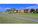 Exterior view of a two-story home on a golf course with a sidewalk at 322 Winding Brook Ln # 103, Bradenton, FL 34212