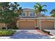 Charming home exterior featuring well-manicured landscaping, brick driveway, and two-car garage at 322 Winding Brook Ln # 103, Bradenton, FL 34212