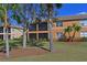 Exterior view of a two-story home with palm trees and manicured lawn at 322 Winding Brook Ln # 103, Bradenton, FL 34212