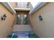 Inviting front entrance with double doors, stone walkway, sconces, and manicured landscaping at 322 Winding Brook Ln # 103, Bradenton, FL 34212