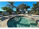 A hot tub with brick pavers, a metal railing, and a view of the landscape at 322 Winding Brook Ln # 103, Bradenton, FL 34212