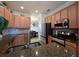 Updated kitchen showcases stainless steel appliances, granite countertops, a tile backsplash, and natural wood cabinets at 322 Winding Brook Ln # 103, Bradenton, FL 34212