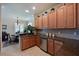 Well-lit kitchen features granite countertops, stainless steel appliances, tile backsplash, and ample wood cabinetry at 322 Winding Brook Ln # 103, Bradenton, FL 34212