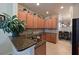 Kitchen featuring granite countertops, wood cabinets, and stainless steel sink at 322 Winding Brook Ln # 103, Bradenton, FL 34212