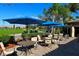 A patio with tables, umbrellas, and views of the golf course at 322 Winding Brook Ln # 103, Bradenton, FL 34212