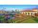View of the tennis courts, courtyard, and clubhouse with tables and chairs at 322 Winding Brook Ln # 103, Bradenton, FL 34212