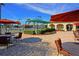 Courtyard view of tennis courts, covered seating, and tables and chairs at 322 Winding Brook Ln # 103, Bradenton, FL 34212