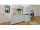 Clean, modern kitchenette featuring white cabinetry, a sink, a microwave, and a refrigerator at 326 E Lake Dr, Sarasota, FL 34232