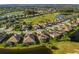 Aerial view of a residential neighborhood with golf course and ponds, showcasing the community layout at 375 Fairway Isles Ln, Bradenton, FL 34212