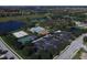An aerial view showcases community amenities including a pool, tennis courts, and playground near residential homes at 375 Fairway Isles Ln, Bradenton, FL 34212