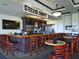 Clubhouse bar featuring a full bar, stools, and table seating at 375 Fairway Isles Ln, Bradenton, FL 34212