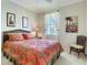 Bedroom featuring a large bed, carpet floors, ceiling fan and a large window at 375 Fairway Isles Ln, Bradenton, FL 34212