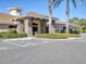 Well-maintained clubhouse entrance with stone accents, holiday wreaths, and lush landscaping at 375 Fairway Isles Ln, Bradenton, FL 34212