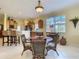 Inviting dining area with wicker furniture, offering a view of the modern kitchen at 375 Fairway Isles Ln, Bradenton, FL 34212