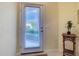 Bright entry door with window and blinds, complemented by neutral walls and a small accent table at 375 Fairway Isles Ln, Bradenton, FL 34212