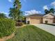 Charming home with a two-car garage, beautifully landscaped yard, and well-maintained lawn at 375 Fairway Isles Ln, Bradenton, FL 34212