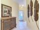 Welcoming foyer with tile flooring, decorative wall art, and a stylish cabinet, leading to the main living areas at 375 Fairway Isles Ln, Bradenton, FL 34212