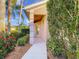 Inviting front entrance with a well-lit walkway surrounded by lush greenery and colorful flowerbeds at 375 Fairway Isles Ln, Bradenton, FL 34212