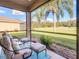 View from the screened lanai overlooking a golf course at 375 Fairway Isles Ln, Bradenton, FL 34212
