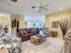 Inviting living room featuring a plush sofa, patterned armchairs, and a stylish coffee table on a soft rug at 375 Fairway Isles Ln, Bradenton, FL 34212