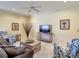 Cozy living room with comfortable seating, a ceiling fan, and neutral décor, creating a relaxing atmosphere at 375 Fairway Isles Ln, Bradenton, FL 34212