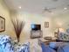 Inviting living room featuring neutral walls, tiled floor, and comfortable seating with a ceiling fan at 375 Fairway Isles Ln, Bradenton, FL 34212
