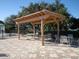 Outdoor pergola with tables and chairs on a brick patio provides a relaxing spot for residents at 375 Fairway Isles Ln, Bradenton, FL 34212