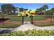 Fenced-in community playground with colorful slides, climbing structures, and ample space for to play at 375 Fairway Isles Ln, Bradenton, FL 34212