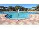 Large community pool with plenty of lounge chairs and umbrellas at 375 Fairway Isles Ln, Bradenton, FL 34212