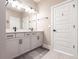 This bathroom features double vanity sinks, modern lighting, and a neutral color scheme at 3802 Savanna Palms Ct, Bradenton, FL 34211