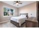 This bedroom features a ceiling fan, neutral carpet, a bed and a dresser at 3802 Savanna Palms Ct, Bradenton, FL 34211