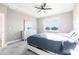 This bedroom features a ceiling fan, neutral carpet, a bed and a dresser with a mirror at 3802 Savanna Palms Ct, Bradenton, FL 34211