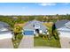 Aerial view of a home with a well manicured lawn, landscaping, and blue accent garage door at 438 Whistler Gln, Bradenton, FL 34212