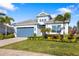 Single-story home with a brick driveway, lush landscaping, and a welcoming blue front door at 438 Whistler Gln, Bradenton, FL 34212