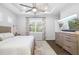 Serene main bedroom featuring a ceiling fan, decorative curtains, and a large window at 438 Whistler Gln, Bradenton, FL 34212