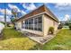 Home featuring a bright sunroom and a well-kept yard, ideal for relaxation and entertainment at 4608 Park Acres Dr, Bradenton, FL 34207