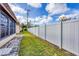 Backyard view showing the lush green grass, fenced perimeter, and the home's exterior at 4608 Park Acres Dr, Bradenton, FL 34207