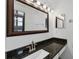 Bathroom featuring a dark granite countertop and modern vanity lights at 4608 Park Acres Dr, Bradenton, FL 34207