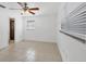 Bright bedroom featuring tile floors, a ceiling fan, and an ensuite bathroom at 4608 Park Acres Dr, Bradenton, FL 34207